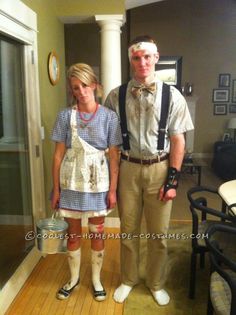 a man and woman dressed up in costume standing next to each other on a wooden floor