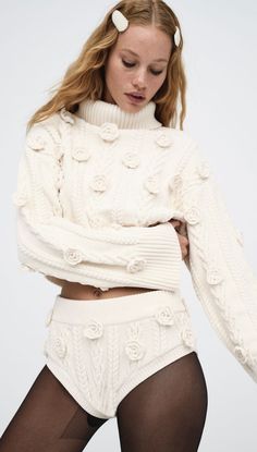 Martina Cropped Sweater | For Love and Lemons The Martina Cropped Sweater by For Love and Lemons features this season's Hottest Trend—3-dimensional Flower Rosettes. Chunky chenille cable knit Rhinestone embellishments Crochet rosettes Cropped length Ribbed hem Fabric & Care 100% PolyesterEco Dry Clean is recommended.Avoid cleaners that use harmful chemicals like "Perc". Luxury Cropped Sweater For Spring, Luxury Cozy Cropped Sweater For Women, Luxury Wool Cropped Sweater For Winter, Luxury Wool Cropped Sweater For Women, Luxury Long Sleeve Cropped Cozy Sweater, Luxury Long Sleeve Cozy Cropped Sweater, Luxury Knitted Long Sleeve Cropped Sweater, Gold For Love And Lemons Dress, For Love And Lemons Sweater