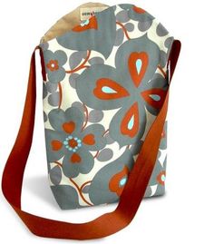 a handbag with an orange and grey flower design