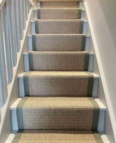 a carpeted staircase leading up to the second floor