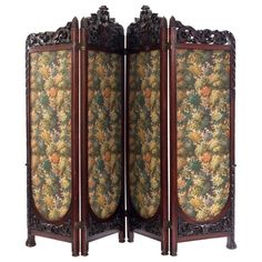 an ornately decorated room divider with flowers and leaves on the sides, set against a white background