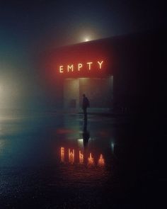 a person standing in front of a building with the word empty on it