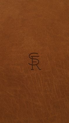 a brown leather book with the letter f on it