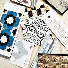 several different types of tile are laid out on the table together, including one with blue and white designs