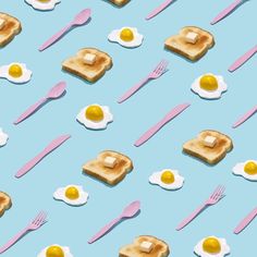 breakfast food with eggs, toast and utensils arranged on a blue background that includes pink forks