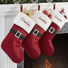 three christmas stockings hanging from a mantel