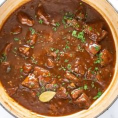 a pot filled with meat and sauce on top of a table