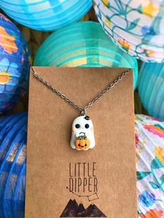 a necklace with an owl and pumpkin on it