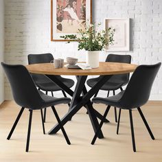 a wooden table with black chairs and a white brick wall in the backround