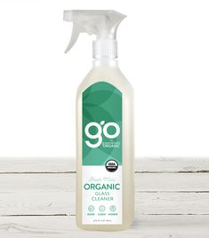 a bottle of organic glass cleaner sitting on top of a wooden table