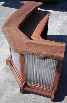 an old wooden case sitting on top of a cement floor next to a black car