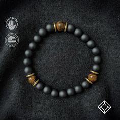 A grounding stone, Onyx is believed to absorb negative energies, alleviates worries and tensions, and eliminates confusion. It helps in being structured and letting go of unhappy thoughts. There is 1 accent Tiger Eye bead, which is repeated 3 times for Balance. A protective stone, Tiger Eye is believed to bring good luck and enabling the mind to focus and make decisions unclouded by emotions. It helps release fear and anxiety while aiding harmony and balance. This bracelet has an elastic band th Male Bracelets, Romantic Gifts For Husband, Release Fear, Pebble Jewelry, Balance Bracelet, Romantic Gifts For Him, Artisan Bracelets, Tiger Eye Bracelet, Healing Necklace