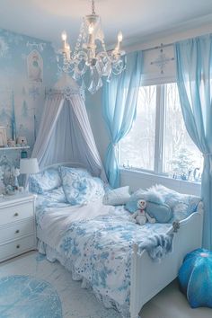 a bedroom decorated in blue and white with snowflakes on the walls, curtains, and bedding