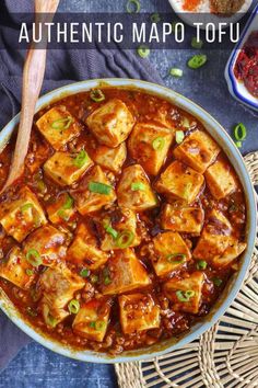 tofu in a bowl with chopsticks on the side and other ingredients surrounding it