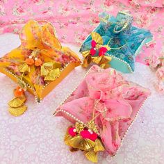 three decorative boxes with gold, pink and blue decorations