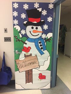 a door decorated with a snowman holding a welcome sign