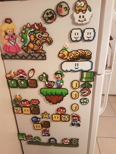 a refrigerator covered in lots of different types of magnets on the side of it