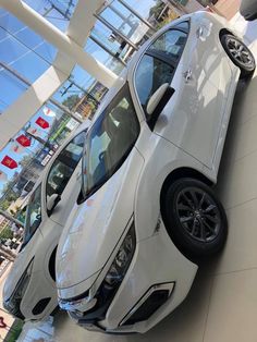 two white cars parked next to each other