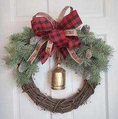 a christmas wreath with a bell hanging from it