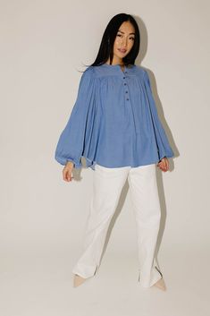 this retro-inspired long sleeve top will take you from summer picnics to fall photoshoots with ease. made with a dark wash denim-esque material, this elevated top features long balloon sleeves + a flowy silhouette. dress it up with trousers + heels, or down with white jeans + sandals. medium wash // high neckline, buttons, balloon sleeves, elastic cuffs paired with our camelot wide leg denim model is 5'8" + wearing a small measurements are approximate + taken while laying flat small : bust 42” l Spring Casual Puff Sleeve Blouse, Billowy Pleated Sleeve Blouse For Spring, Billowy Blouse With Pleated Sleeves For Spring, Spring Bishop Sleeve Blouse With Elastic Sleeves, Spring Blouse With Bishop And Elastic Sleeves, Spring Trendy Peasant Top With Puff Sleeves, Trendy Spring Peasant Top With Puff Sleeves, Spring Cotton Blouse With Lantern Sleeves, Fall Denim Puff Sleeve Top