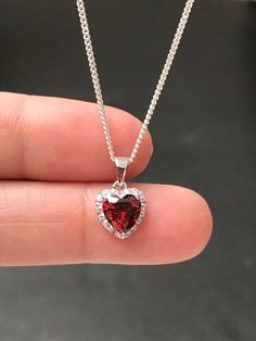 "Small Sterling Silver Garnet CZ Heart Necklace Garnet is the birthstone for January, this makes a great gift for those loved ones born January. Metal: All components are made from solid .925 Sterling Silver Stone: Cubic Zirconia Center Stone size: 7mm Center Stone Carat Weight: 1.6ct Measurement: pendant height is 14mm (0.55\") including bail and 10mm (0.39\") wide Choose Chain Length At Checkout Please feel free to Convo me with any questions before purchasing. Please view policy before purcha Heart-shaped Cubic Zirconia Birthday Jewelry, Cubic Zirconia Heart Necklace With Gemstone For Valentine's Day, Heart Necklace With Cubic Zirconia For Valentine's Day, Heart-shaped Cubic Zirconia Jewelry Gift, Valentine's Day Heart Necklace With Cubic Zirconia Gemstone, Heart-shaped Cubic Zirconia Jewelry For Valentine's Day, Cubic Zirconia Heart Necklace With Gemstone, Crystal Jewelry For Valentine's Day Gift, Crystal Jewelry Valentine's Day Gift For Her