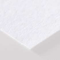 a white sheet of paper that is laying on top of a table, with the edge partially visible