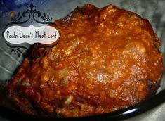 a close up of food in a bowl on a table with a sign that reads paula dei's meat loft