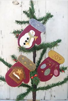 a small christmas tree decorated with mittens and snowmen on it's branches