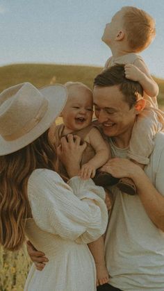 a man, woman and child are standing in a field