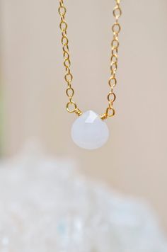 "White Quartz Teardrop Necklace in Sterling Silver or 14k Gold Filled. Available as a set. White Quartz, also known as Snow Quartz or Milky Quartz, is said to dispel negative thoughts and emotions and bring about positive perspectives. It aids in becoming more hopeful and wise, as well. Perfect with anything, this necklace is handcrafted with a natural white quartz gemstone. It can be made in either sterling silver or 14kt gold filled. Matching earrings are available as well when ordering a set. Dainty White Faceted Necklace, White Drop Jewelry With Delicate Chain, White Gemstone Birthstone Pendant Necklace, White Pendant Birthstone Necklace With Gemstone, White Delicate Chain Drop Necklace, White Delicate Drop Chain Necklace, White Faceted Briolette Jewelry, White Briolette Crystal Necklace Gift, White Birthstone Pendant Necklace With Gemstone