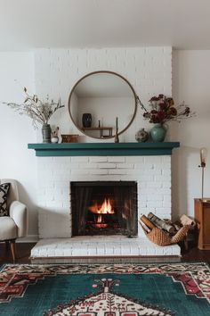 a living room with a fire place and rug