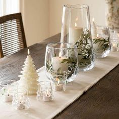 a table with candles and christmas decorations on it