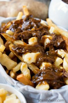 a bowl filled with fries covered in gravy