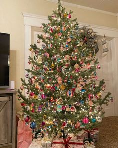 a decorated christmas tree with presents under it