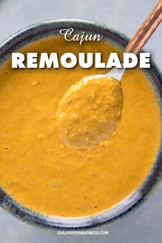 a spoon full of soup with the words cajun remoulade above it