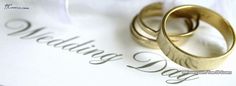 two gold wedding rings resting on top of a marriage day document with the word love written in cursive writing