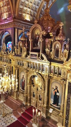 the interior of a church with gold and red decorations