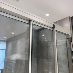 two glass doors are open on the inside of a room with no one in it