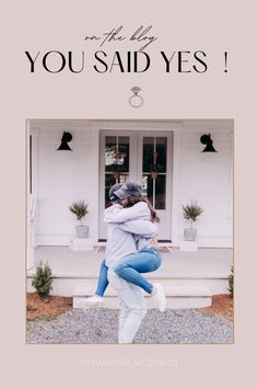 two people hugging each other in front of a house with the words, you said yes