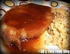 meat and rice are on a plate with gravy in the middle, ready to be eaten