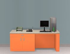 an orange desk with a computer monitor and keyboard