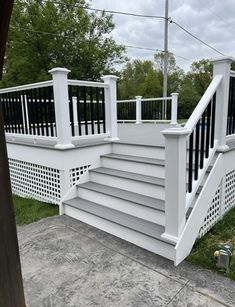 a white deck with black railing and trelliss