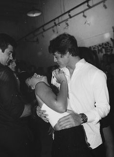 black and white photograph of a man hugging a woman on the dance floor at a party