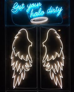 an illuminated sign with angel wings on the front and back of it that says get your halos dirty