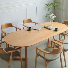 a wooden table with four chairs around it