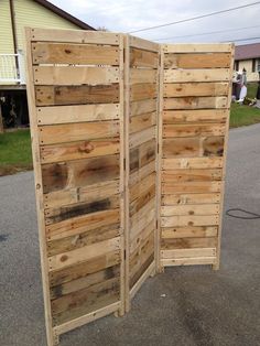 an open wooden door sitting on the side of a road