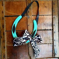 a black and white bow tied to a wooden wall