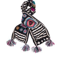 a black and white scarf with multicolored flowers on the ends, two tassels