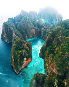 an instagram photo taken from the top of a mountain with blue water and green land