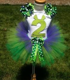 a green and white number two birthday tutu with polka dots on the bottom is shown